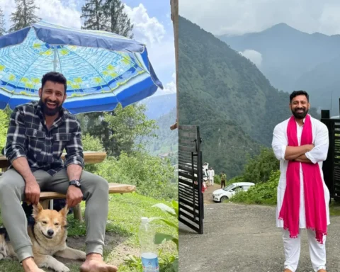 Rajat Dalal enjoying nature in the mountains with his dog and smiling in traditional attire, highlighting the lifestyle aspect of Rajat Dalal Networth.